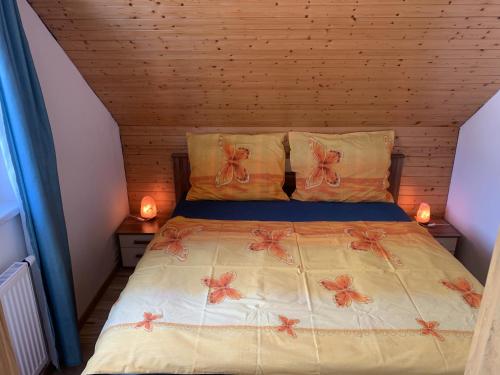 a bedroom with a bed with bows on it at Květinové apartmány Horní Planá in Horní Planá