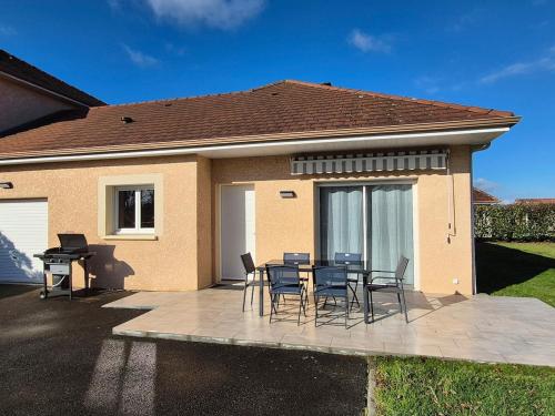 a patio with chairs and a table in front of a house at Le gîte de Midi for 6 pers - Quiet garden in Uzein