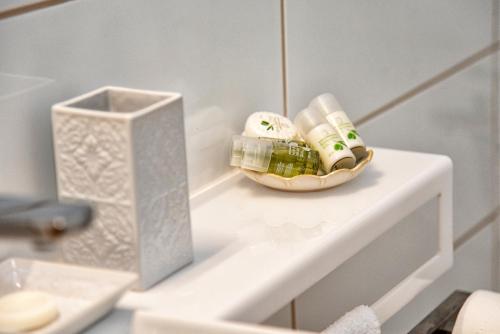 a shelf with two bottles and a box on it at Shell & Pebble in Acharavi
