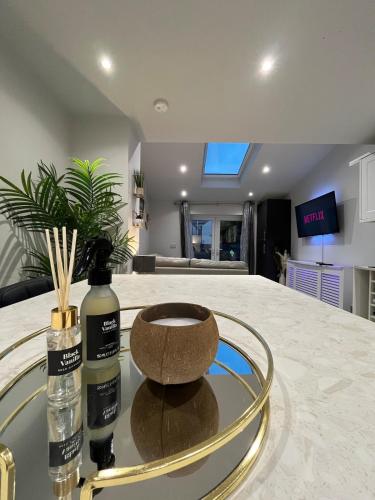 a glass table with two bottles on top of it at Luxury Seaside Town House in Bangor