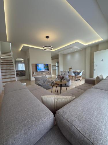 a living room with two beds and a couch at Tea Residence, Gjiri i Lalzit DeLux Villa in Durrës