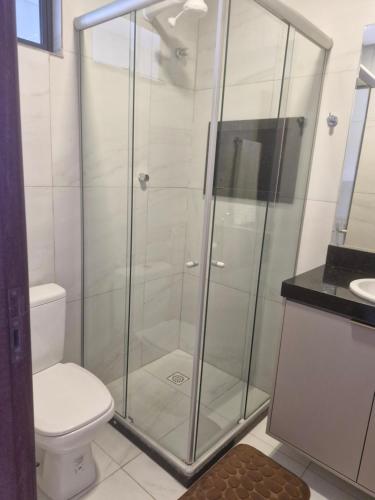 a glass shower in a bathroom with a toilet at Pousada Âncora in Conde