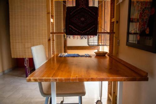 a wooden table in a dining room with two chairs at Filocase - What a view! in SantʼAgata deʼ Goti