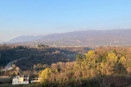 a view of a valley with trees and a road at Filocase - What a view! in SantʼAgata deʼ Goti