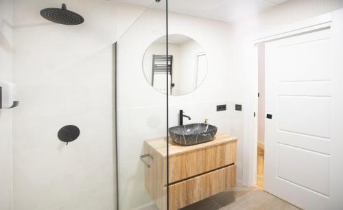 a bathroom with a sink and a mirror at El Rincon de Marieta in Huesca