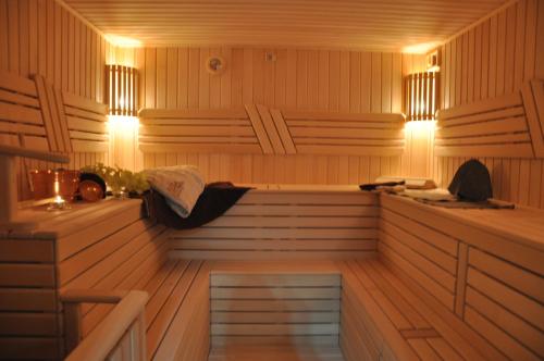 a sauna with a bench and lights in it at Hotel Villa Natali in Chişinău