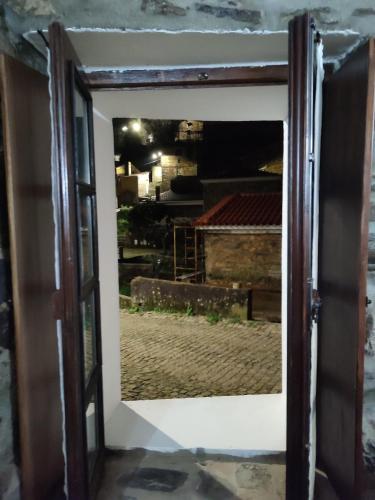 an open door with a view of a building at Casa Iris Cunqueiros in Sobreira Formosa