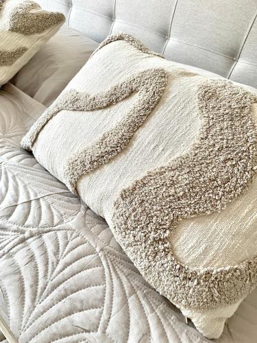 a bed with a white blanket and a pillow on it at Anne in Sankt Pölten