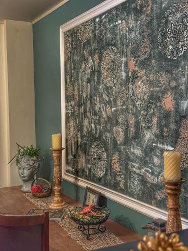 a large painting on a wall in a room with a table at Inspire View - Boutique in Bran