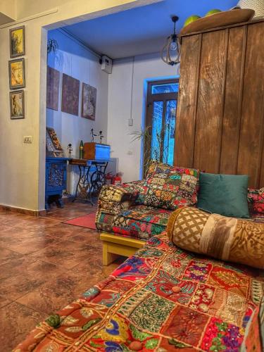 a living room with a bed and a couch at Inspire View - Boutique in Bran