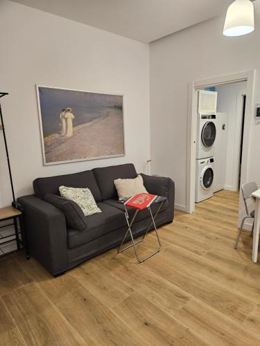 a living room with a couch and a painting of a dog at Loft moderno en Lezkairu UAT01756 in Pamplona