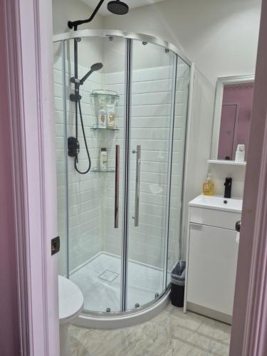 a glass shower in a bathroom with a sink at Private Room near Airport in Mississauga