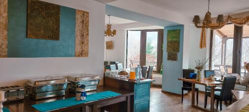 a kitchen with blue walls and a counter and a table at Inspire View - Boutique in Bran