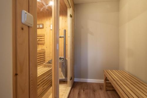 a walk in shower in a room with a bench at Spacious 120m2 Water Villa With Sauna Near Amsterdam in Aalsmeer