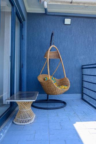 a basket hanging from a wall next to a table at Ripple House in Namulanda
