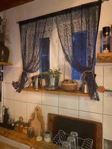 a kitchen with two windows and a counter top at Vila Agroturizam Kućica Mostar-Welcome bikers in Mostar