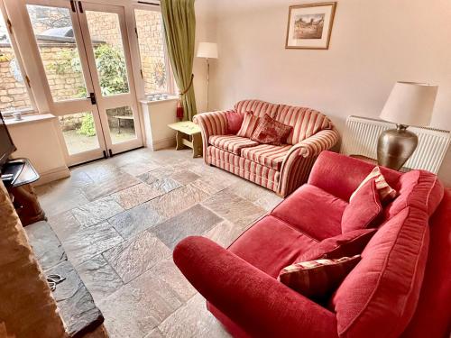 a living room with a couch and a chair at Misty View - 2 Bed Cottage in Winchcombe in Winchcombe