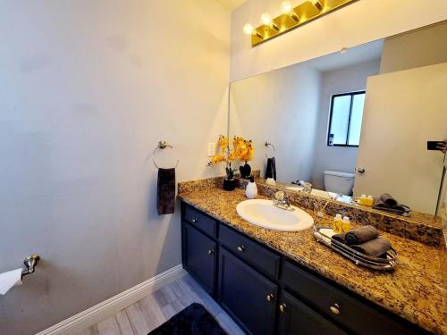 a bathroom with a sink and a large mirror at Treasure Bay-3BR Pool & Hot Tub Oasis Near T Strip in Las Vegas