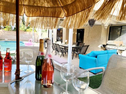 a table with wine bottles and glasses on a patio at Treasure Bay-3BR Pool & Hot Tub Oasis Near T Strip in Las Vegas
