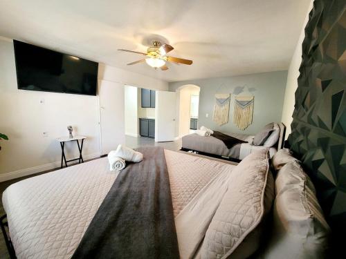 a bedroom with a large bed with a ceiling fan at Treasure Bay-3BR Pool & Hot Tub Oasis Near T Strip in Las Vegas