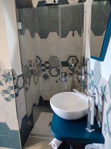 a bathroom with a sink and a shower at Maruzzé luxury room in Albori