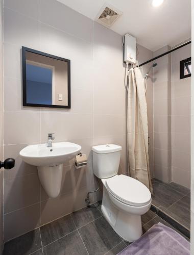 a bathroom with a toilet and a sink at Diamond Hall Cebu - 201 in Cebu City