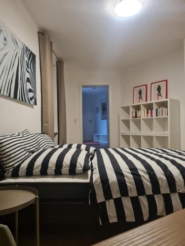 a bedroom with a bed with black and white stripes at Ferienwohnung mit Burgblick in Mayen