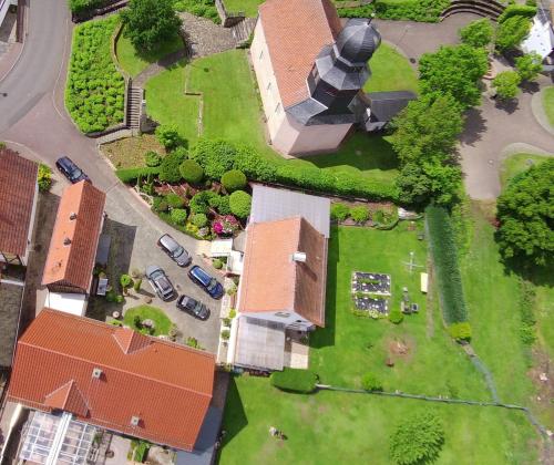 an overhead view of a house with a church at Hof Eckens - Ferienhaushaus Marie in Wildeck Bosserode in Wildeck
