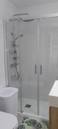 a shower with a glass door in a bathroom at Casa Dolores in Puerto de Mazarrón