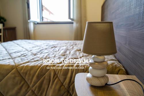 a lamp sitting on a table next to a bed at Room to Dream in San Valentino Torio