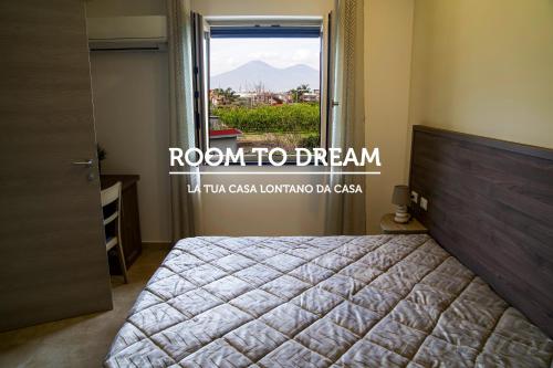 a bedroom with a bed and a window with a view at Room to Dream in San Valentino Torio