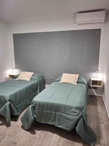 two beds sitting next to each other in a room at Rincón de paso in Ciudad Lujan de Cuyo