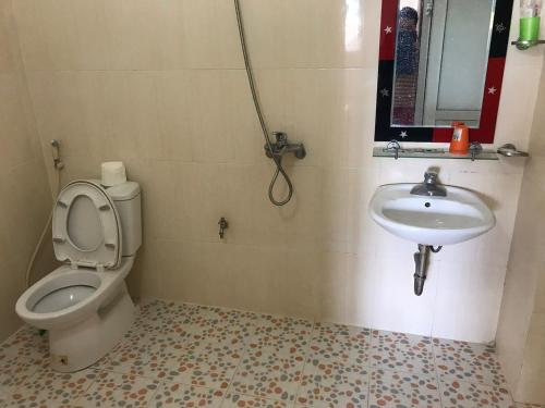 a bathroom with a toilet and a sink at Minh An in Dien Bien Phu
