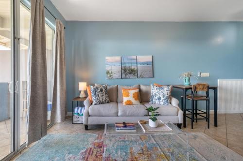a living room with a couch and a table at Gulf Place Cabanas in Santa Rosa Beach