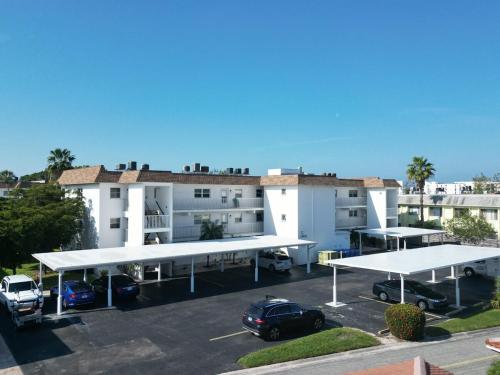 a parking lot with two large white buildings at 2 bed 2 bath centrally located on Siesta Key in Sarasota