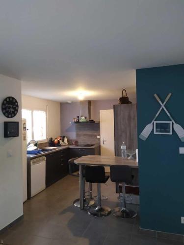 une cuisine avec une table et des chaises dans l'établissement Maison face à l'île des ebihens, à Saint-Cast-le-Guildo