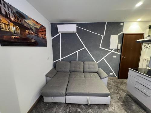 a couch in a room with a wall at Anna Apartment in Padova