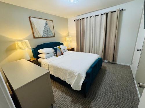 a hotel room with a bed and a window at Private 2 bedroom duplex in Stafford