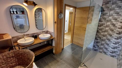 a bathroom with two sinks and a shower at Chez Bernadette in La Bresse