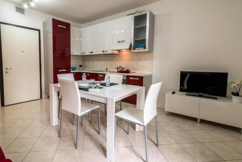 a kitchen and dining room with a white table and chairs at Residence Milano Bicocca in Milan