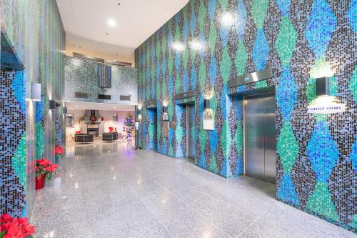 a lobby with blue and green tiles on the walls at Modern & Cozy Home in the Heart of Downtown Vancouver in Vancouver