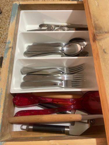 a drawer filled with silver utensils in a drawer at Nel mio immaginario in Città della Pieve