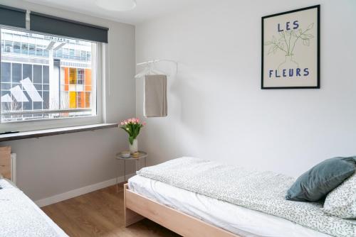 a bedroom with a bed and a window at Chmielna Central Apartments in Warsaw