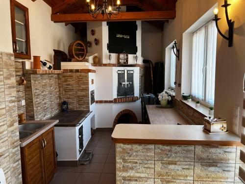 a kitchen with a stove and a fireplace in it at Fortuna Apartman in Kőszeg