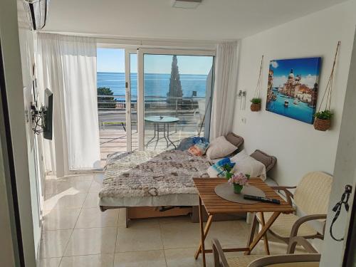 a living room with a couch and a table at One minute to the beach in Becici