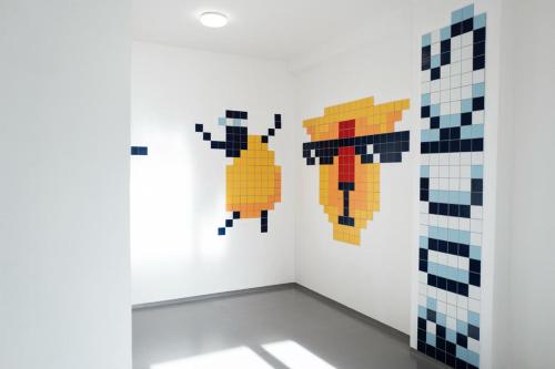 a room with two pixel art figures on the wall at Beskydy House in Rožnov pod Radhoštěm
