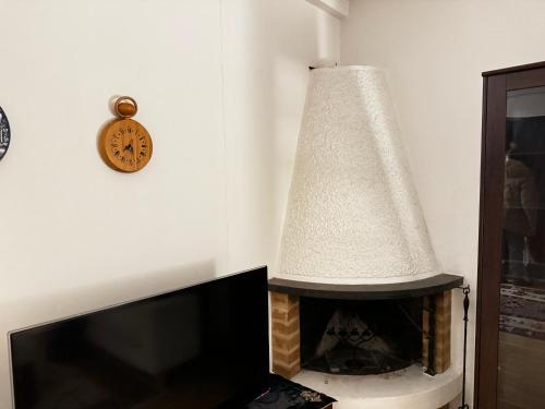 a lamp and a fireplace in a living room at Cozy Independent House with Free Parking and 20 mins to center in Helsinki
