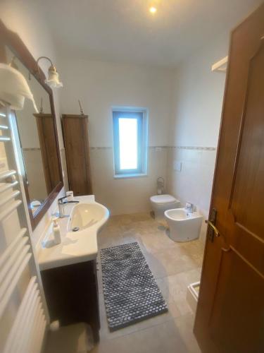 a bathroom with a sink and a toilet at Casa LorEnzo in Manziana