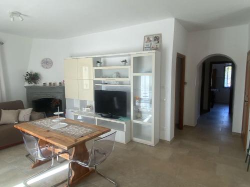 a living room with a table and a tv at Casa LorEnzo in Manziana