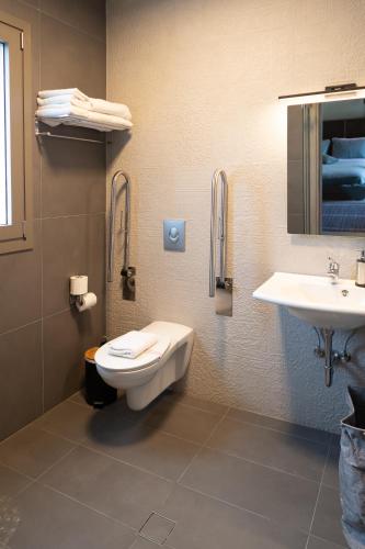 a bathroom with a toilet and a sink at Akti Vigla Apartments in Mytilini